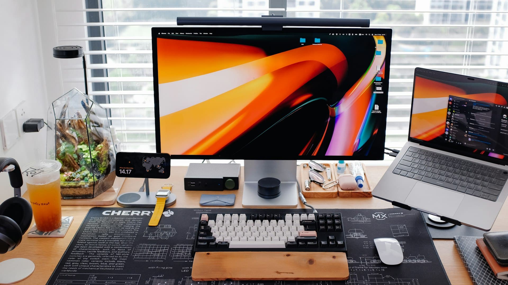 A modern home office desk with a laptop connected to a Thunderbolt 4 docking station, two external monitors, a mechanical keyboard, and a wired mouse, with clean cable management.