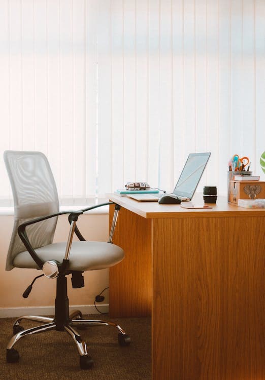 A modern ergonomic office chair at a home desk setup