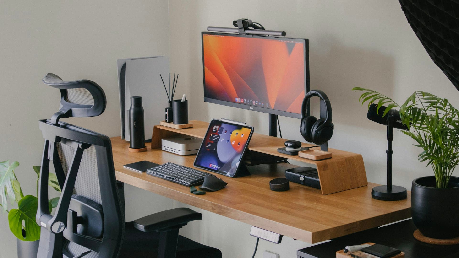 A flat-plug power strip mounted under a clean home office desk with multiple devices plugged in and cables routed neatly along the desk edge.