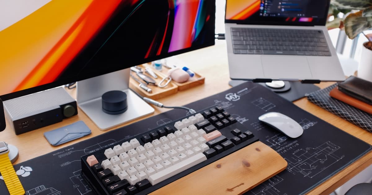 A Logitech MX Keys S keyboard and MX Anywhere 3S mouse sitting side by side on a clean wooden home office desk, both connected wirelessly through a single USB receiver.