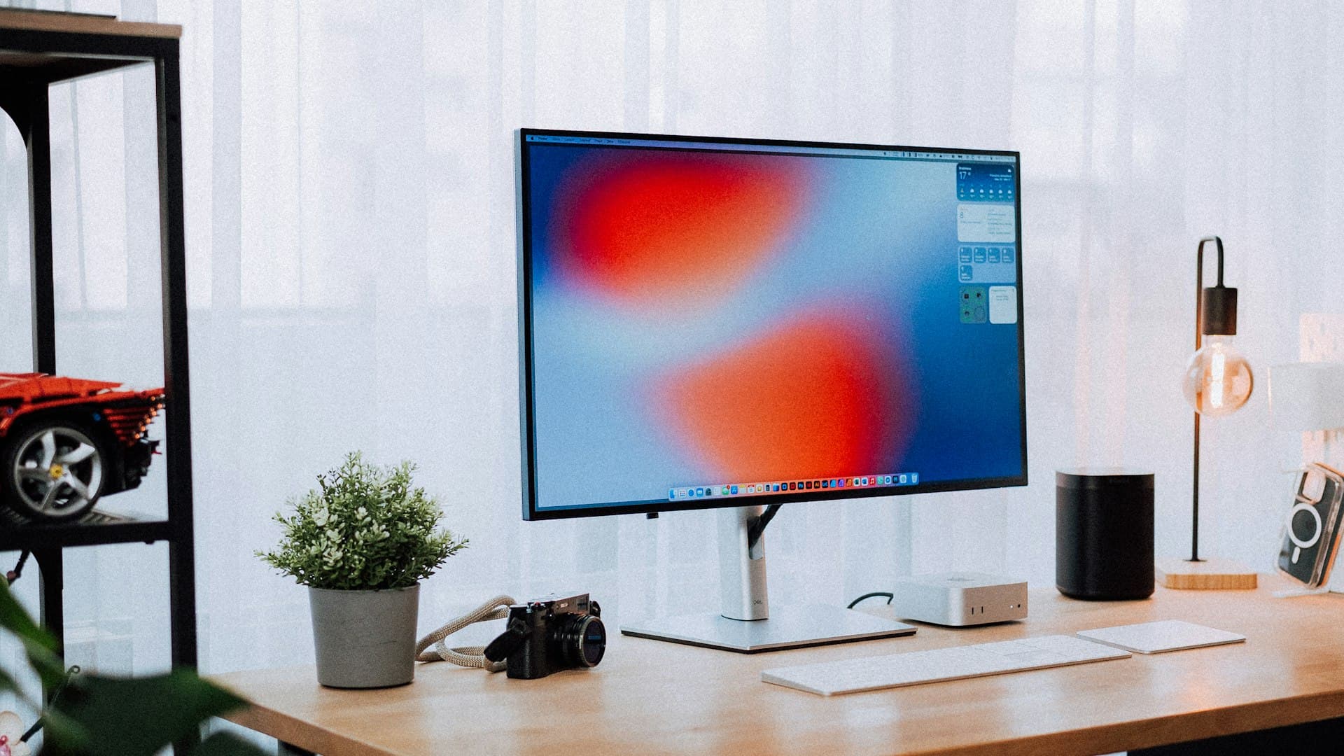 A quiet home office with acoustic panels on the wall, heavy curtains over the window, and a white noise machine on the desk.